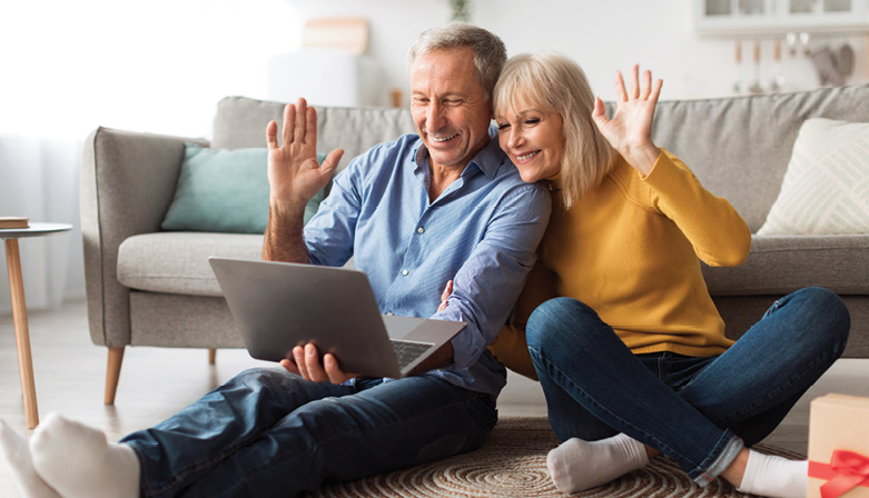 senior-couple-video-calling-waving-hello-to-laptop-2022-12-16-07-13-07-utc